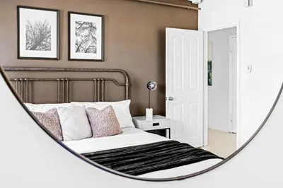 a bedroom with a bed in a mirror at New Stylish Sanctuary - King Beds - Sloans Lake in Denver