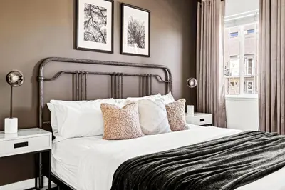 a bedroom with a large white bed with two night stands at New Stylish Sanctuary - King Beds - Sloans Lake in Denver
