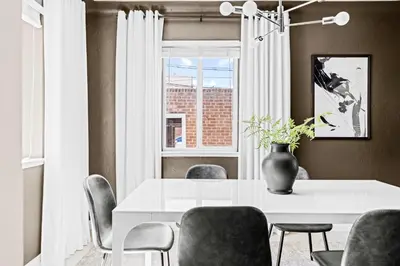 a dining room with a white table and chairs at New Stylish Sanctuary - King Beds - Sloans Lake in Denver