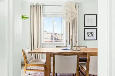 a dining room with a table and chairs and a window at Modern Comfort - King Beds - Walk to Sloans Lake in Denver