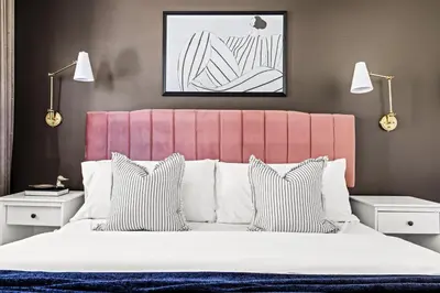 a bedroom with a large bed with a pink headboard at Modern Comfort - King Beds - Walk to Sloans Lake in Denver