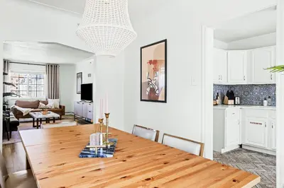 a kitchen and dining room with a wooden table at Modern Comfort - King Beds - Walk to Sloans Lake in Denver