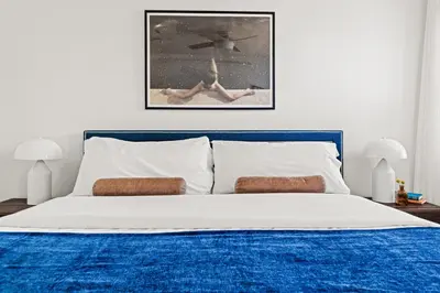 a bedroom with a bed with a blue and white comforter at Bright & Modern Retreat - King Beds - Sloans Lake in Denver