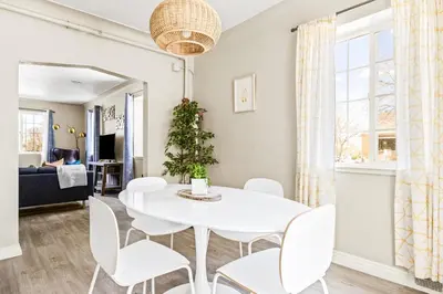 a white dining room with a white table and chairs at Stylish City Retreat - King Beds - Walk to Sloans Lake in Denver