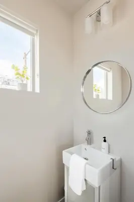 a white bathroom with a sink and a mirror at Center of LoHi - Roof Deck - Walk Everywhere in Denver