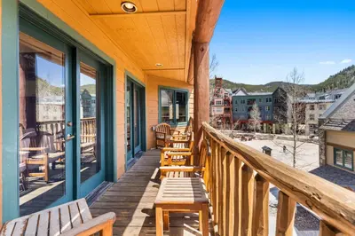 a porch with wooden benches on a building at Arap Ldg 8130 in Keystone
