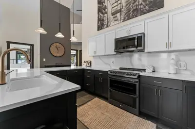 a kitchen with black and white cabinets and a sink at Arap Ldg 8130 in Keystone