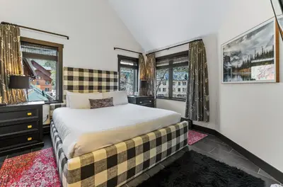 a bedroom with a bed and two windows at Arap Ldg 8130 in Keystone