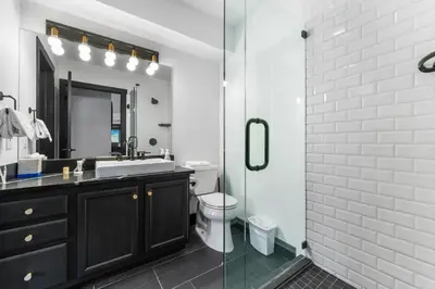 a bathroom with a black vanity and a glass shower at Arap Ldg 8130 in Keystone