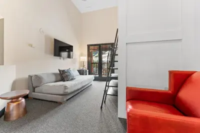 a living room with a red couch and a chair at Arap Ldg 8130 in Keystone