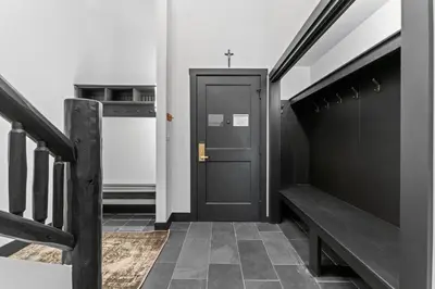 a hallway with a black door and a bench at Arap Ldg 8130 in Keystone