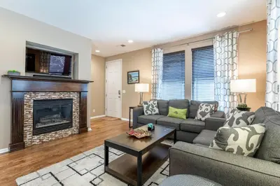a living room with a couch and a fireplace at Spacious Family Friendly Townhome in Central Park in Denver