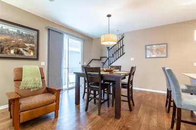 a dining room and living room with a table and chairs at Spacious Family Friendly Townhome in Central Park in Denver