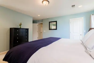 a bedroom with a large bed and a black dresser at Spacious Family Friendly Townhome in Central Park in Denver
