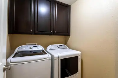 a small laundry room with a washer at Spacious Family Friendly Townhome in Central Park in Denver