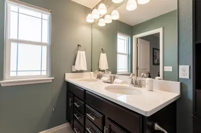 a bathroom with two sinks and a large mirror at Spacious Family Friendly Townhome in Central Park in Denver