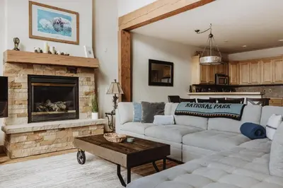 a living room with a couch and a fireplace at Hot Tub MTN Views - Free Shuttle - Central WP in Winter Park