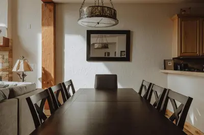 a dining room with a wooden table and chairs at Hot Tub MTN Views - Free Shuttle - Central WP in Winter Park