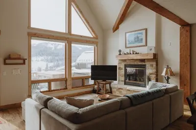a living room with a couch and a fireplace at Hot Tub MTN Views - Free Shuttle - Central WP in Winter Park