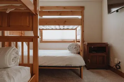 a bedroom with two bunk beds and a window at Hot Tub MTN Views - Free Shuttle - Central WP in Winter Park