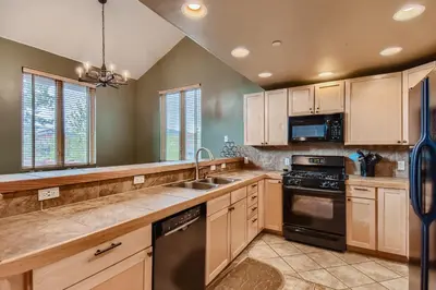 a kitchen with wooden cabinets and a sink at 42 Burgundy 4Br 3,5Ba townhouse in Silverthorne