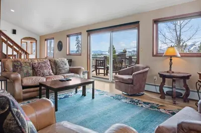 a living room with a couch and a table at 5BR Mountain Retreat with Hot Tub and Sauna in Silverthorne