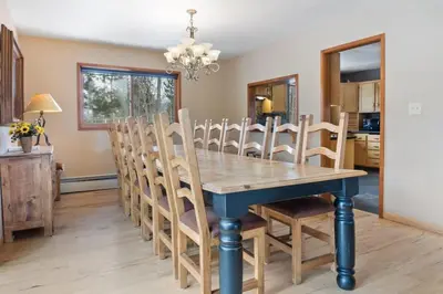 a dining room with a blue table and chairs at 5BR Mountain Retreat with Hot Tub and Sauna in Silverthorne