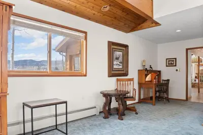 a room with a table and a desk and a window at 5BR Mountain Retreat with Hot Tub and Sauna in Silverthorne