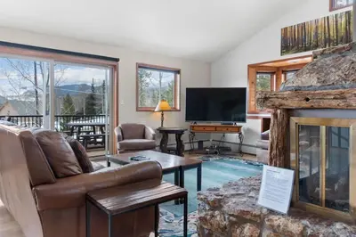 a living room with a fireplace and a television at 5BR Mountain Retreat with Hot Tub and Sauna in Silverthorne