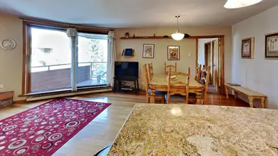 a living room with a table and a dining room at 135 Marina Place in Dillon
