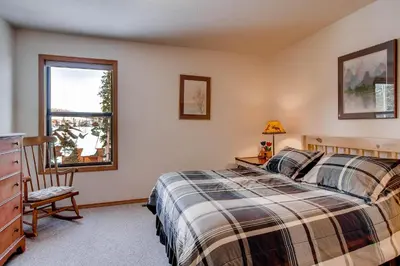 a bedroom with a bed and a dresser and a window at 2028 Ryan Gulch in Silverthorne