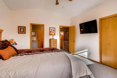a bedroom with a bed and a flat screen tv at 2028 Ryan Gulch in Silverthorne