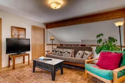 a living room with a couch and a tv at 2028 Ryan Gulch in Silverthorne
