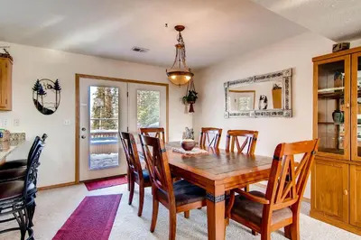 a dining room with a wooden table and chairs at 2028 Ryan Gulch in Silverthorne