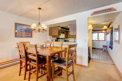 a kitchen and dining room with a wooden table and chairs at 207 Point Dillon in Dillon