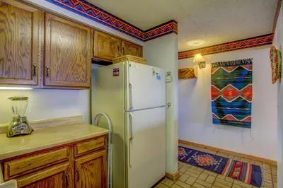 a kitchen with a white refrigerator and wooden cabinets at 207 Point Dillon in Dillon
