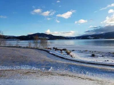 a snowy road next to a body of water at 207 Point Dillon in Dillon