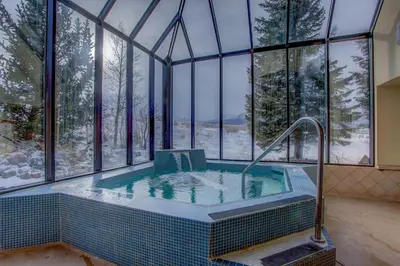 a jacuzzi tub in a room with windows at 207 Point Dillon in Dillon