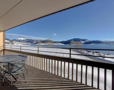 a balcony with a table and a view of the water at 207 Point Dillon in Dillon