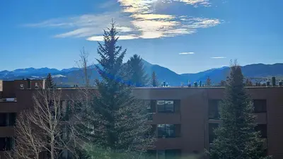 a building with trees and mountains in the background at 233 Marina Place in Dillon