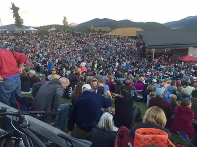 a large crowd of people sitting in the grass at 233 Marina Place in Dillon
