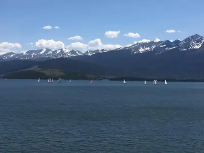 a group of sailboats in a large body of water with mountains at 233 Marina Place in Dillon