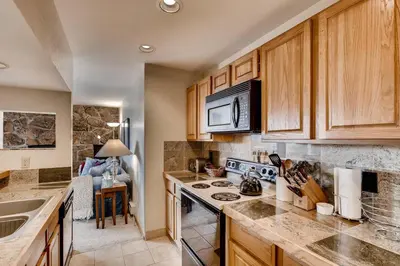 a kitchen with wooden cabinets and a stove top oven at 233 Marina Place in Dillon