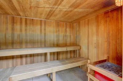 a small wooden sauna with a bench in it at A203 Treehouse in Silverthorne