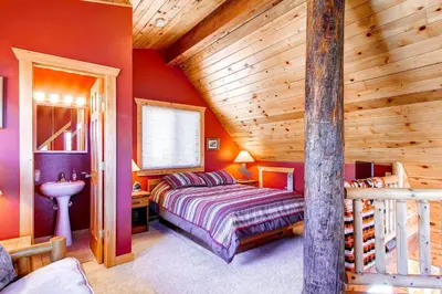 a bedroom with a bed and a wooden ceiling at 597 Deerpath in Dillon