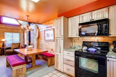 a kitchen and dining room with a table in a cabin at 597 Deerpath in Dillon