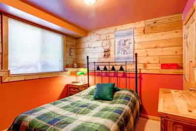 a bedroom with a bed and a wooden wall at 597 Deerpath in Dillon