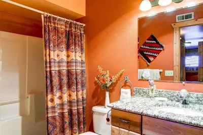 a bathroom with a toilet and a sink and a mirror at 597 Deerpath in Dillon