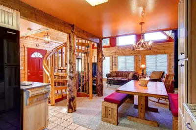 a dining room and living room in a log cabin at 597 Deerpath in Dillon