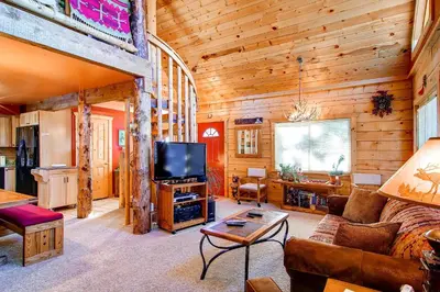 a living room with a couch and a tv in a cabin at 597 Deerpath in Dillon